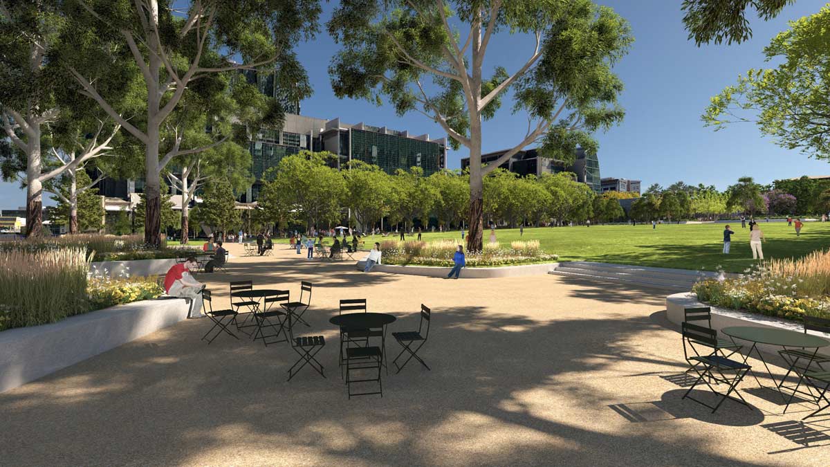 Ground-level render of people sitting at café-style tables beneath mature eucalyptus trees at University Square, with a large open lawn stretching into the background near the Metro Tunnel's Parkville Station.