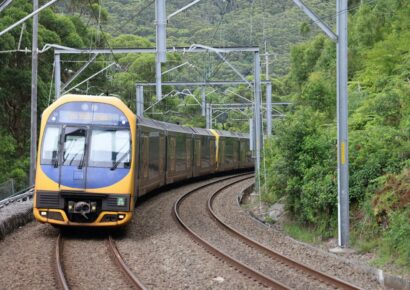 A Sydney Trains service rounds a curve through bushland on a corridor affected by the Sydney to Melbourne train shutdown in May