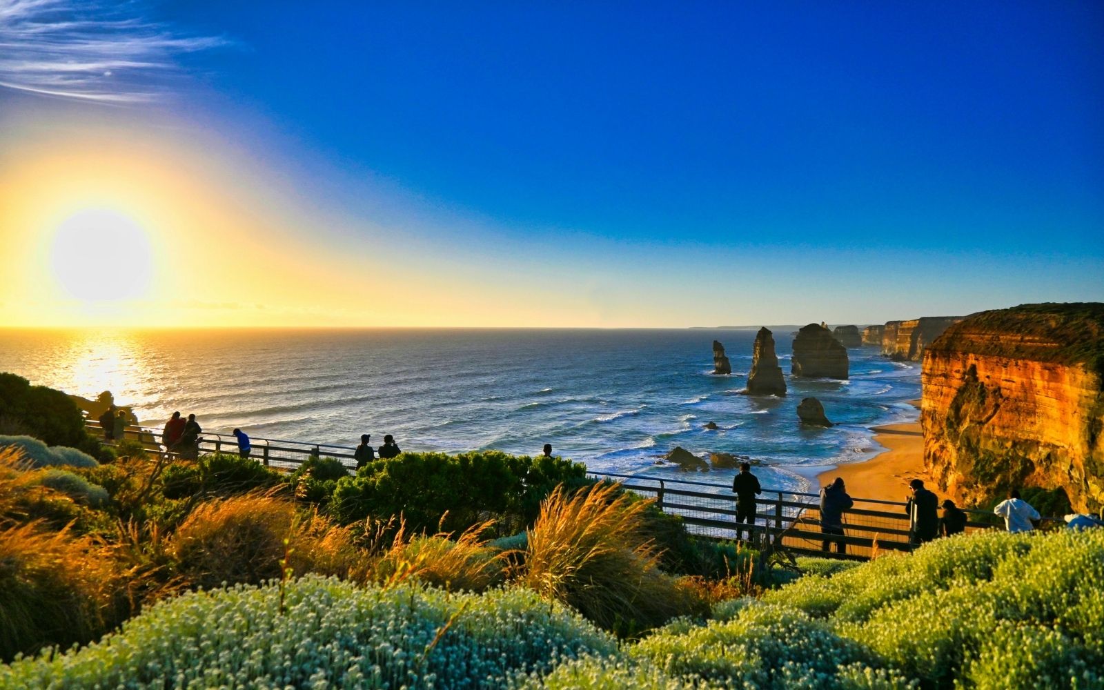 Visitors watch the sun set over the Twelve Apostles from the viewing platform at Port Campbell National Park