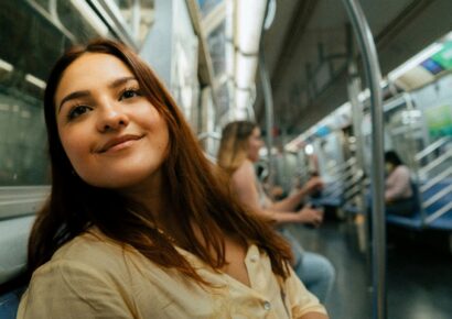 Alt text: A commuter smiles while riding Melbourne trains during free public transport