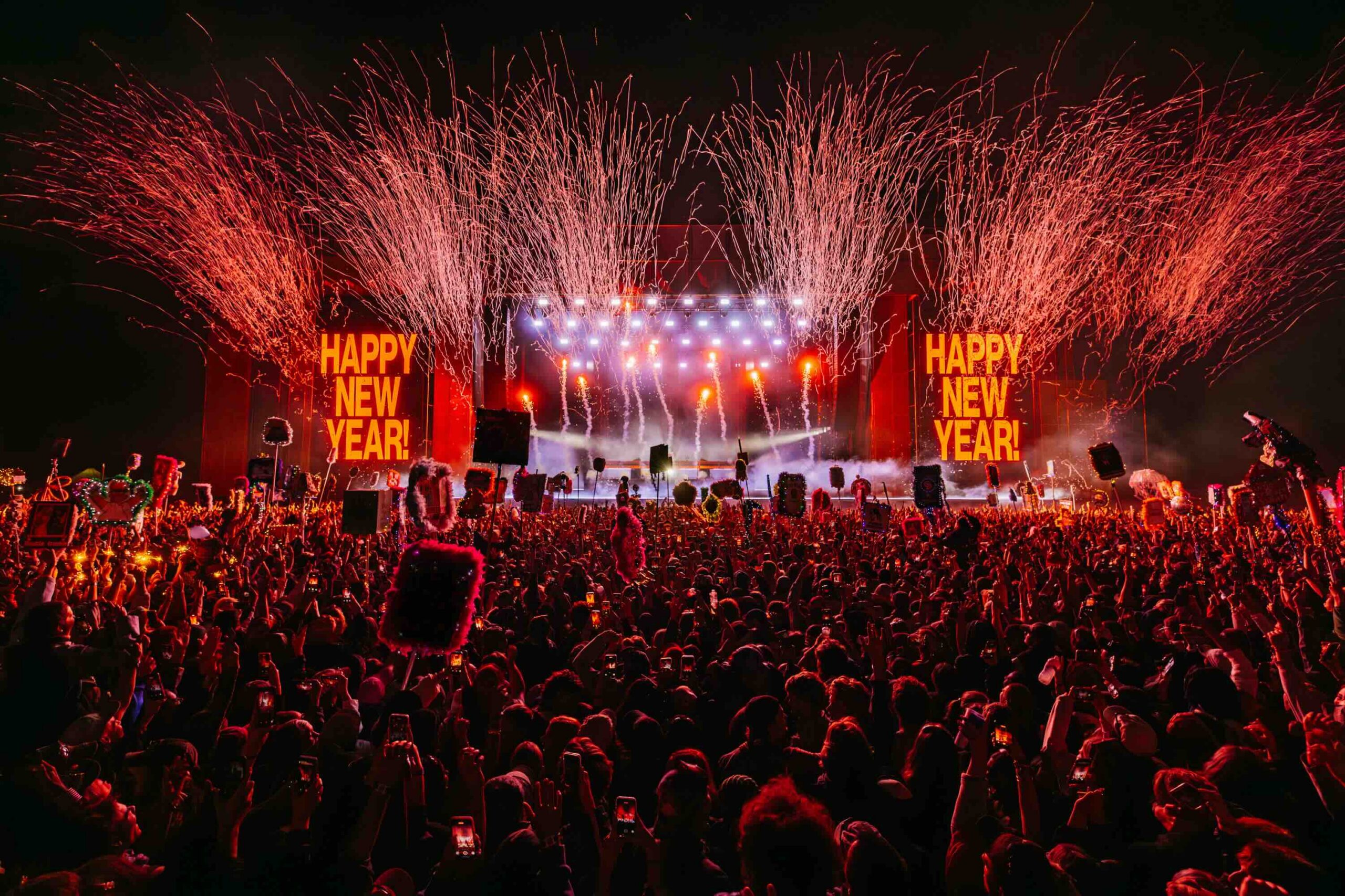 Fireworks arc over the main stage as Happy New Year screens light up the crowd at Beyond The Valley, the moment the BTV lineup builds towards.